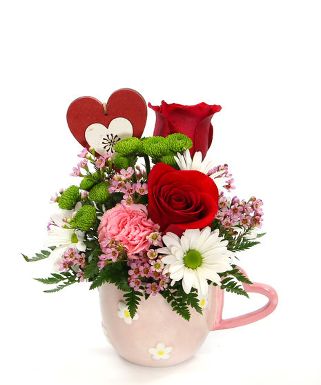 This bouquet stirs together a mix of carnations, daisies and accents arranged with care and topped off with a heart pick. The ultimate treat to brew up smiles & warm hearts.