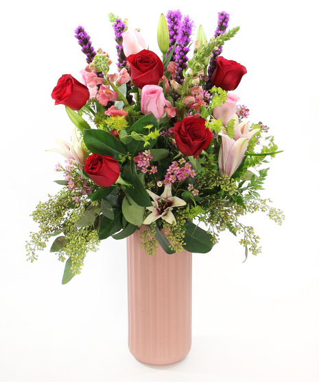 in pinks, Love Story features roses, Oriental lilies, snapdragons, liatris and more.  Arranged in a pink cylinder vase, this bouquet is a perfect expression of romance.