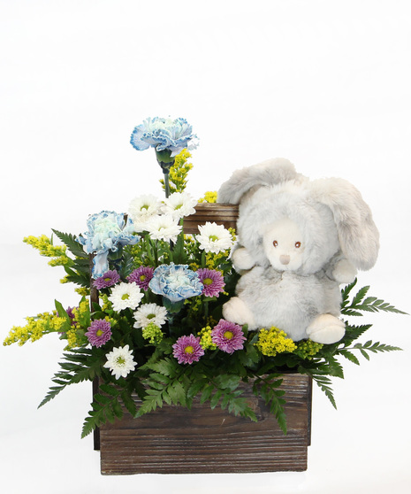 Our New Arrival bouquet is available in pink or blue tones, this design comes nestled in a wooden box, accompanied by a plush bunny. 