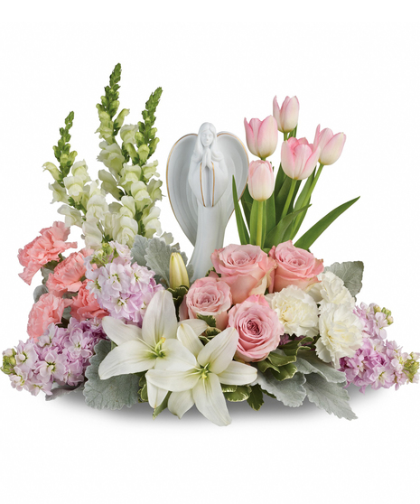 Show them you care with this gorgeous display of roses, lilies and tulips, gracefully surrounding a timeless angel sculpture keepsake.